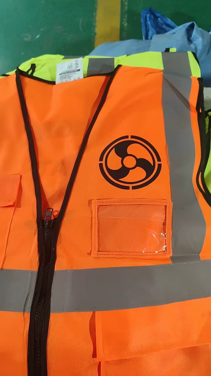 Front of orange Drone Operation safety vest with DOM mark